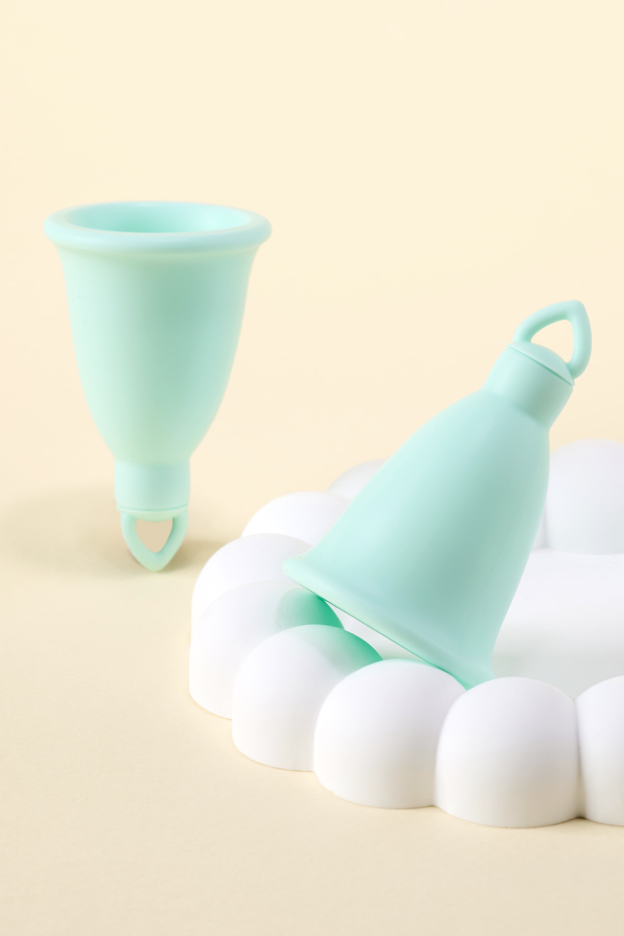 CozyLeaf menstrual cups on a soft cream background